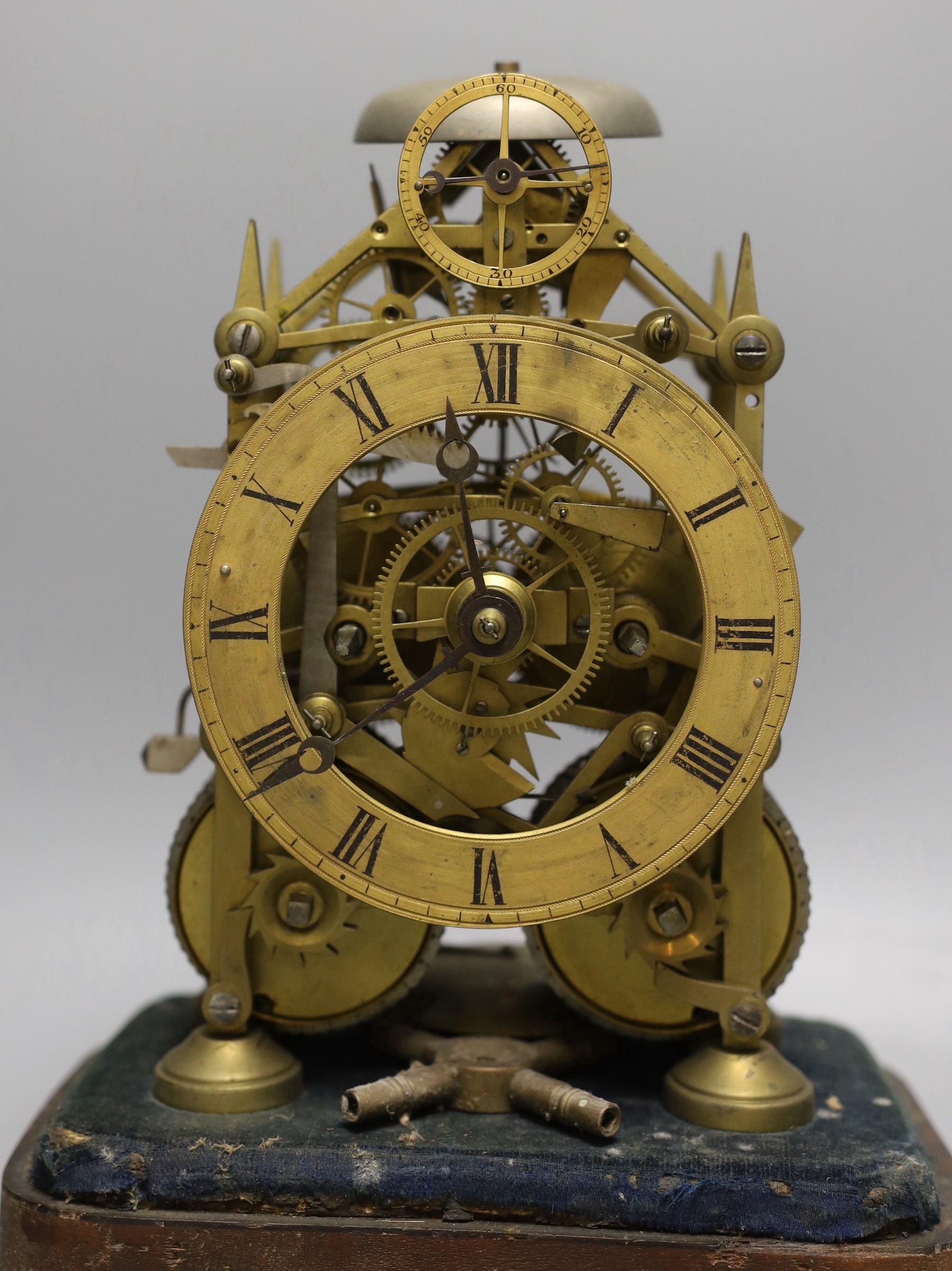 A 19th century brass twin fusee skeleton clock in perspex case with key and pendulum